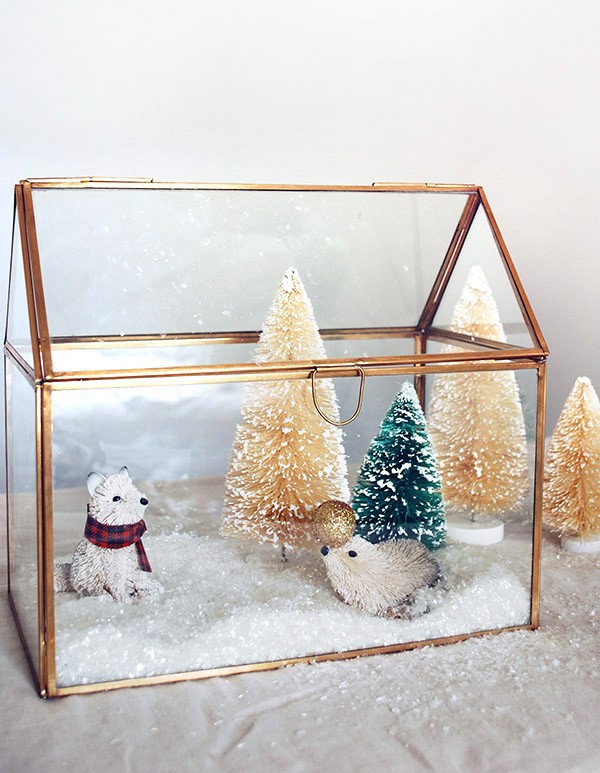 Create a mini winter wonderland with a brass house box and decorations from West Elm. Photo by Lisa Tilse for We Are Scout.