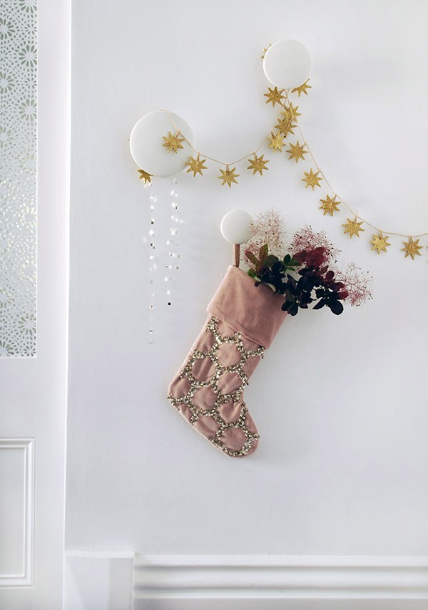 Gorgeous stocking and garland details from West Elm. Photo by Lisa Tilse for We Are Scout.