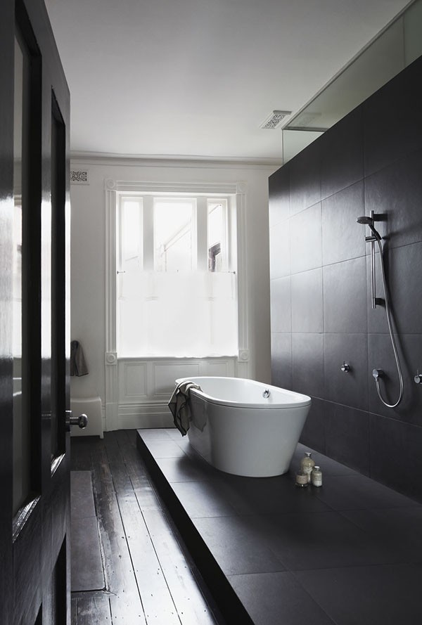 Whiting Architects - amazing black and white bathroom with raised wet area.