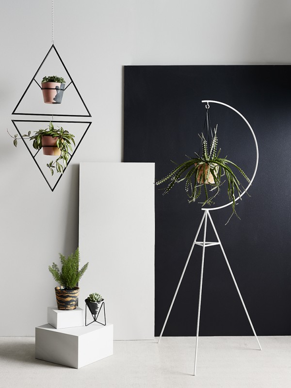 Individually crafted resin pots and modernist-inspired wire plant stands and hangers by Capra Designs.
