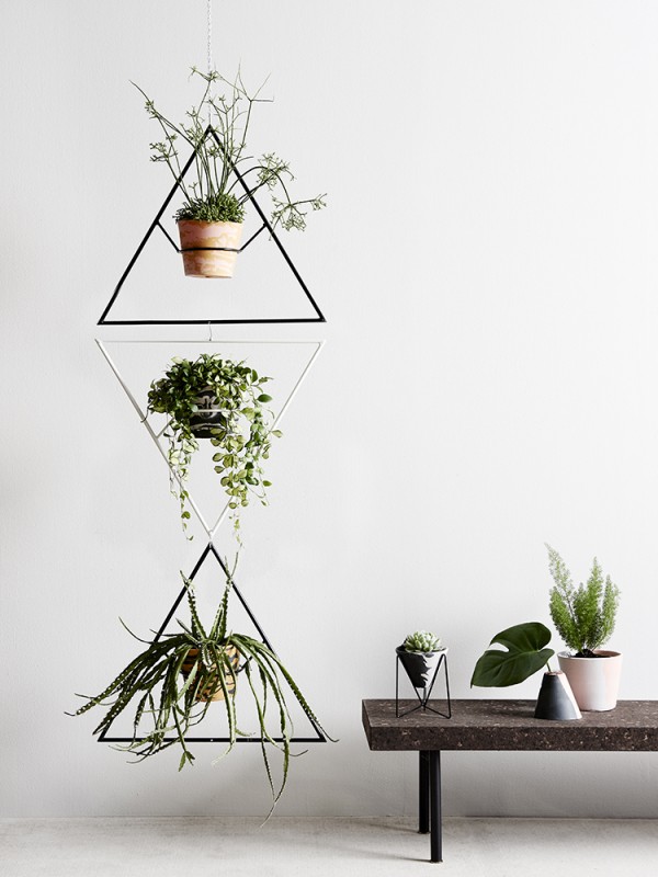 Individually crafted resin pots and modernist-inspired wire plant stands and hangers by Capra Designs.