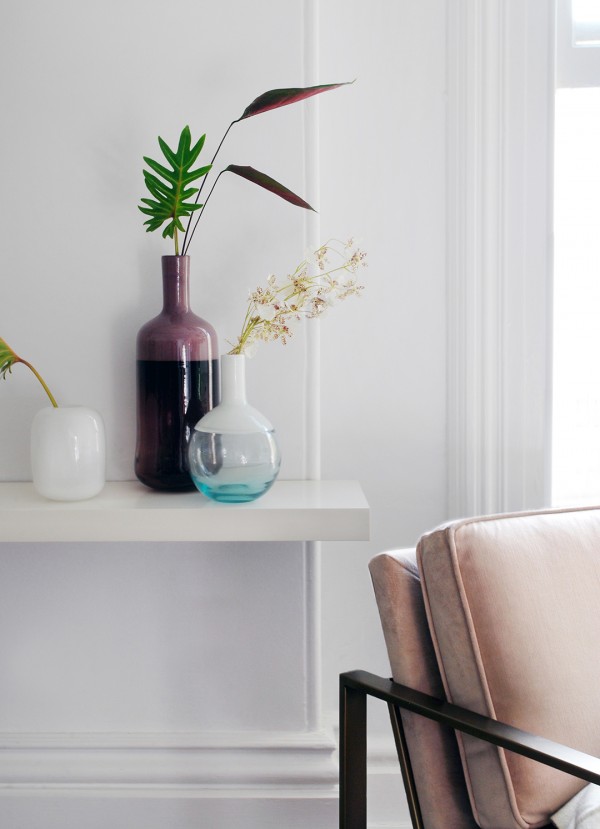 Glass vessels and pink chair from West Elm