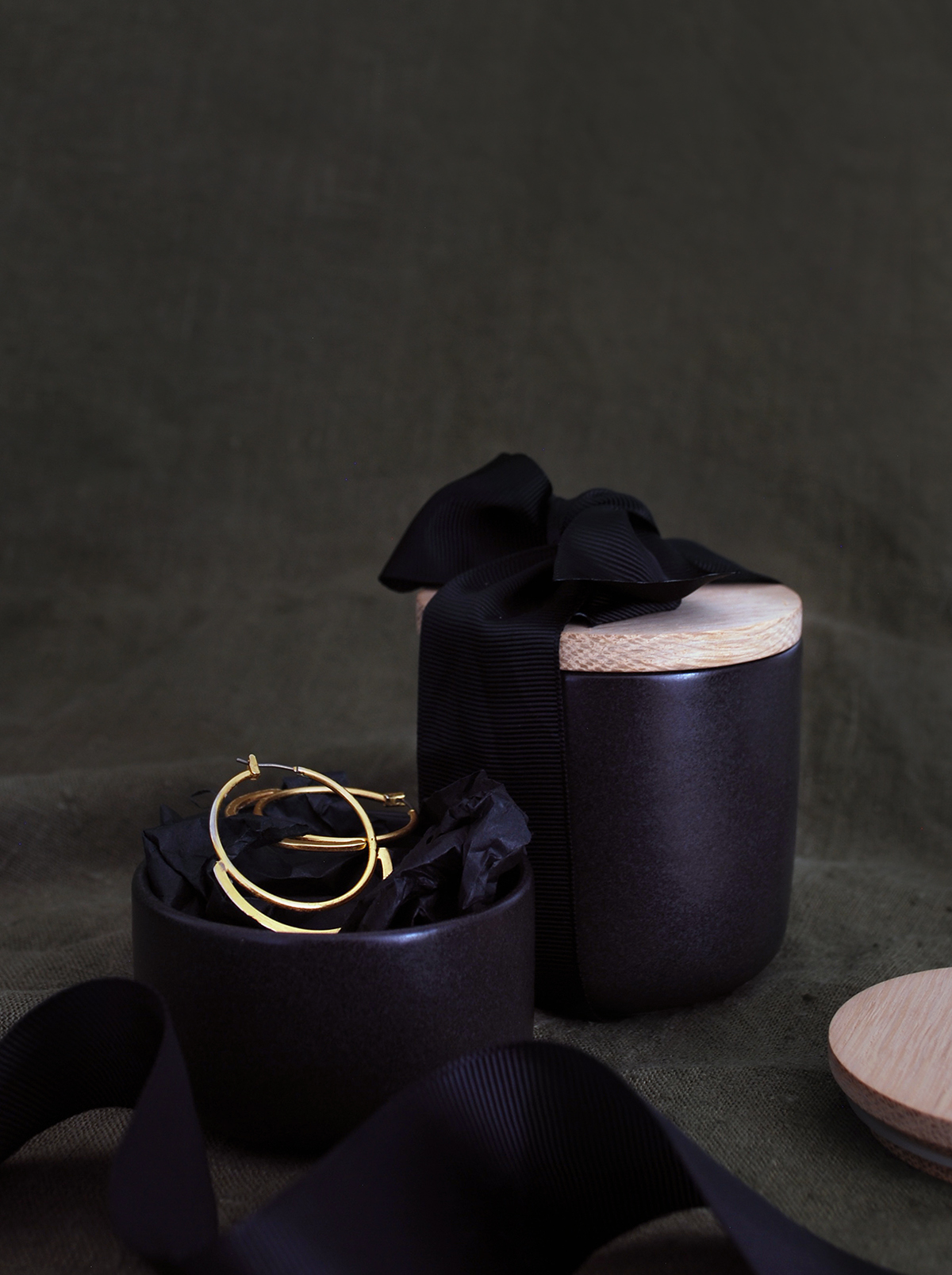 Simple ideas for extraordinary gift wrapping. Matte black kitchen cansiters look amazing tied with thick black ribbon.